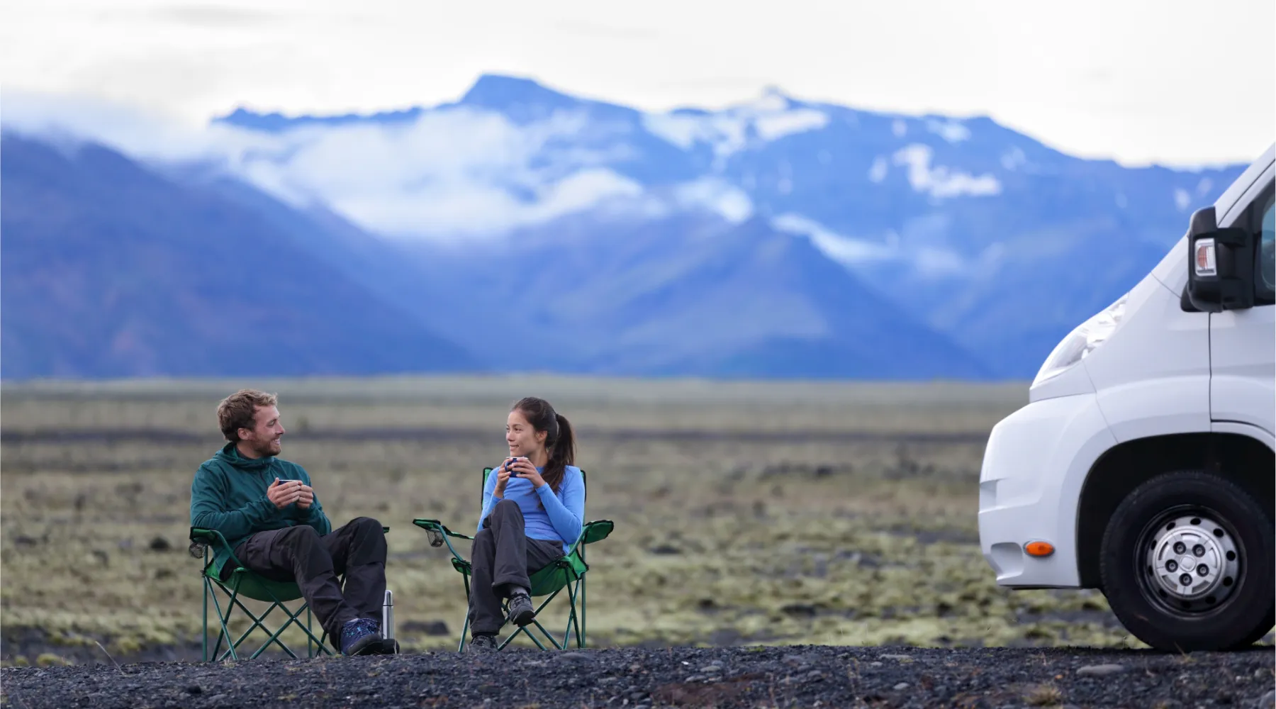Couple sitting outside their motorhome